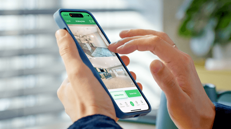 Agent using the AgentUp mobile app to review and manage real estate listing photos on a smartphone.