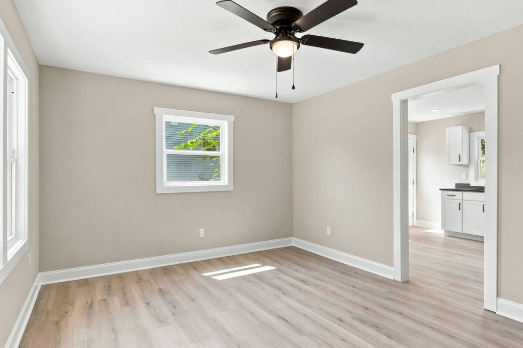 Real estate photo editor showing an empty dining room before virtual staging