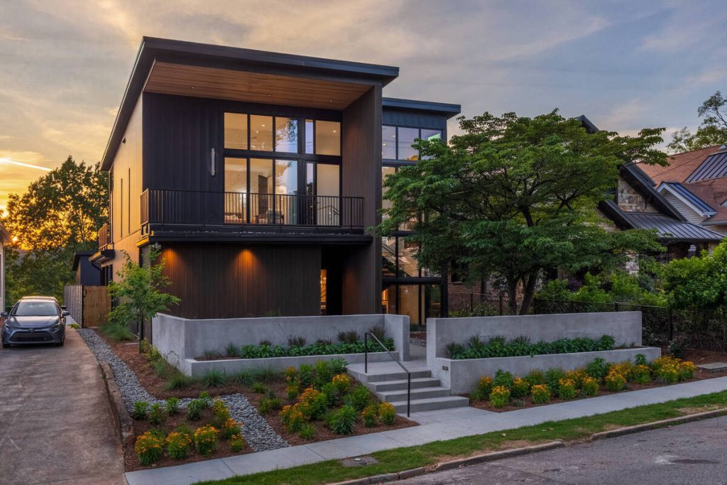 Virtual twilight photo of a modern home exterior with warm interior lighting